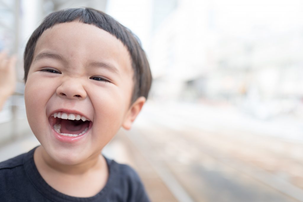 a child smiling with teeth