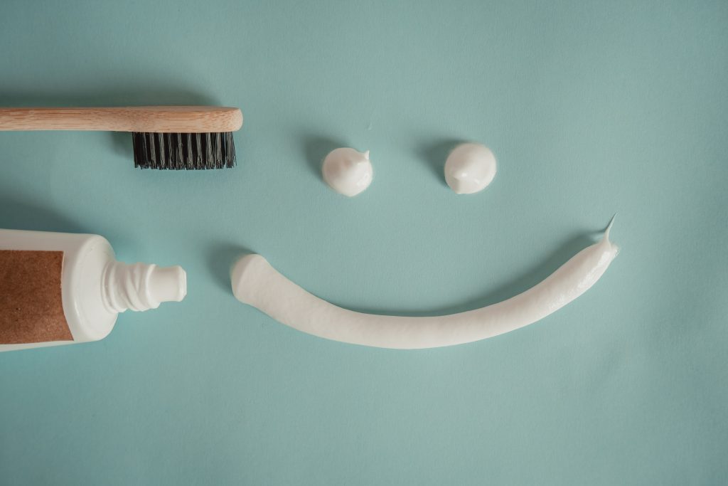 toothbrush and toothpaste forming a smiley face