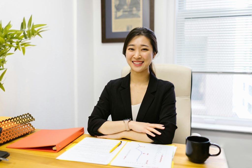 woman smiling with straight teeth sitting down in an office