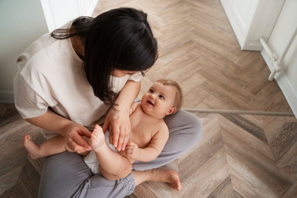 Mom holding and looking at baby on her lap