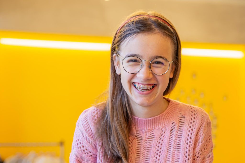 a girl with braces during orthodontic treatment