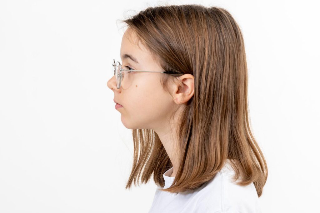 side profile of girl with glasses
